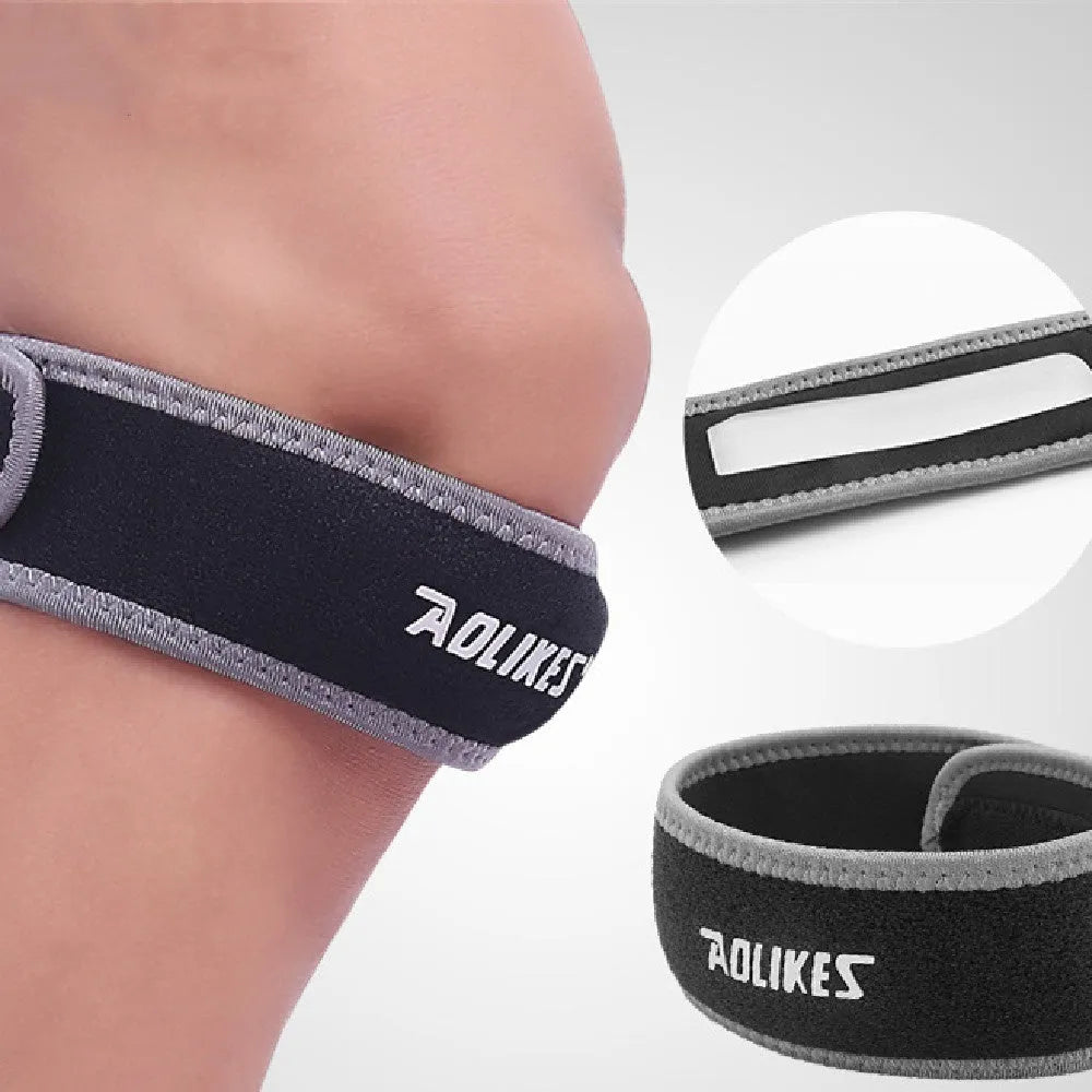 Black and grey patella retinaculum knee support strap for adult sports use.
