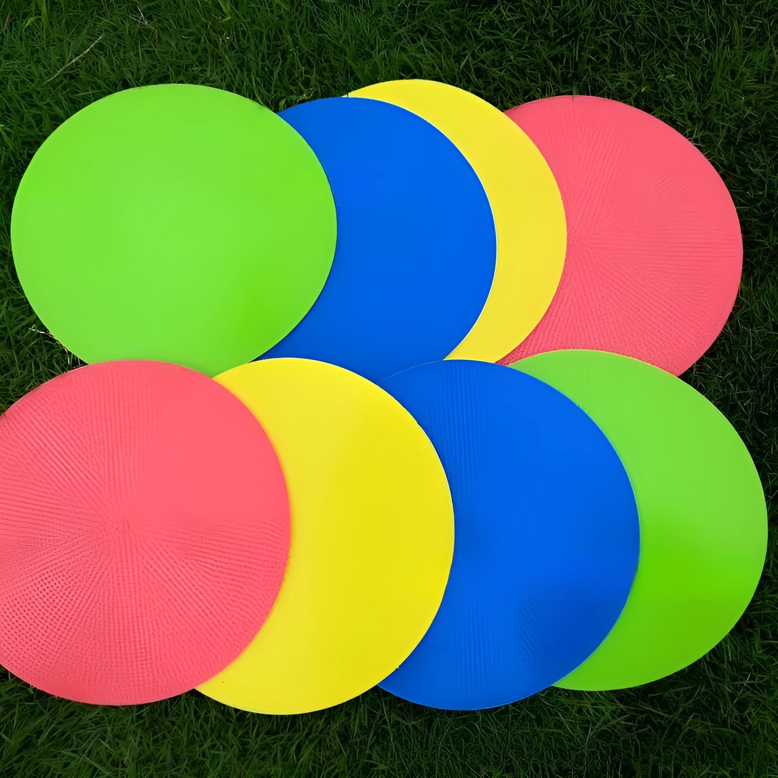 Soft coloured football training marker disc on grass field for target practice