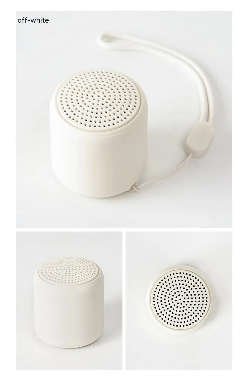 Mini portable wireless Bluetooth speaker in black with rounded edges and fabric grille, 45x48mm size