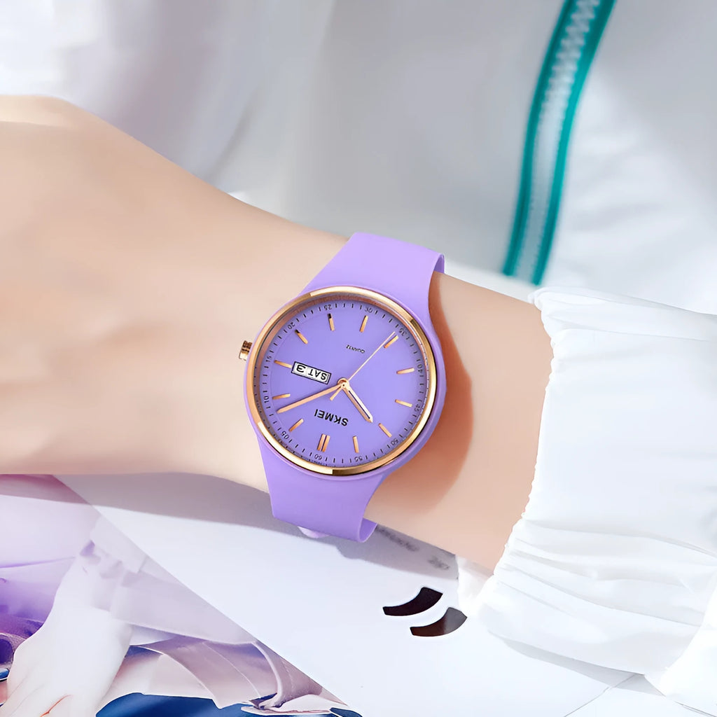 Women's silicone strap quartz watch with 42mm dial showing six colour options: white, purple, black, pink, dark blue, and light blue