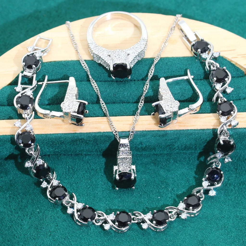 Bridal zircon four-piece jewellery set showing necklace, bracelet, earrings and ring in alloy with water wave chain