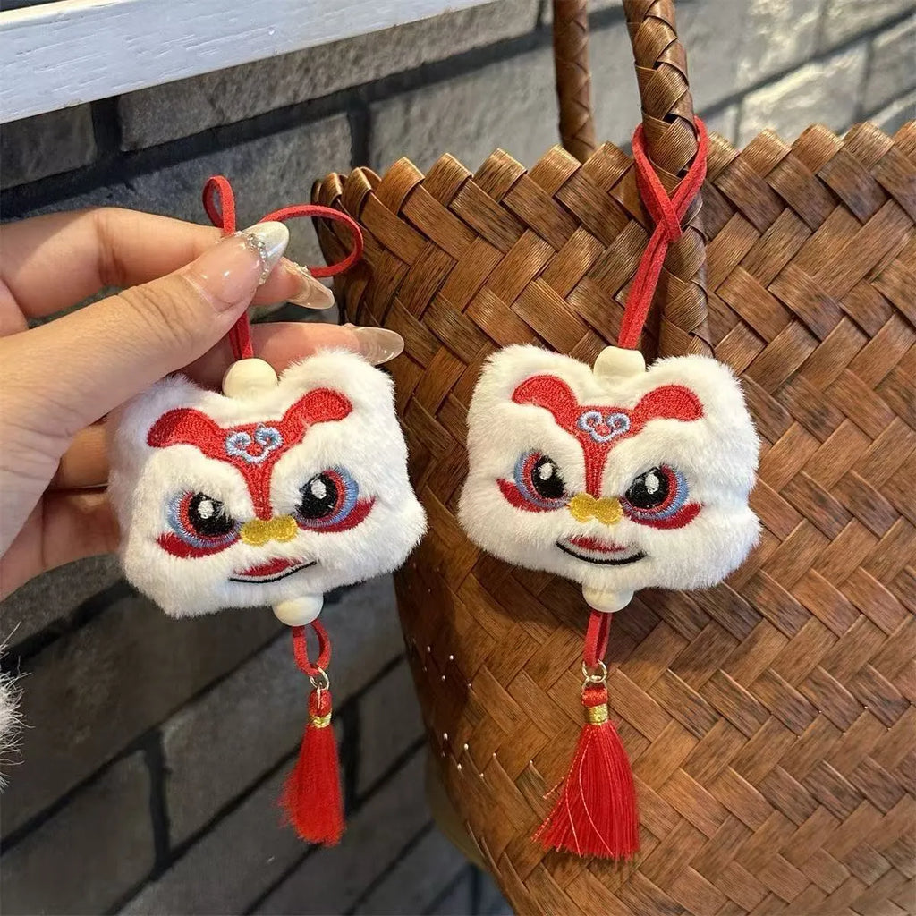 Chinese style plush lion keychain ornament with tassel and star stone accents in blue or yellow