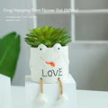 Cartoon style ceramic hanging foot flowerpot for succulents on a desktop