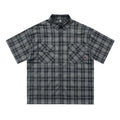 Men's black and brown plaid shirt with embroidered letter detail on chest, short sleeves, lapel collar