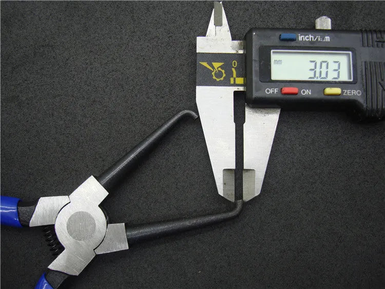 Caliper tubing pliers with iron construction and rubber-coated jaws for automotive fuel line connector work.