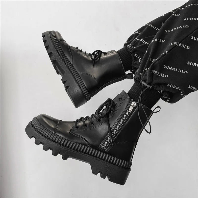 Black Dr. Martens men's platform ankle boots with side zip and fly weave pattern on frosted leather.