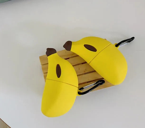 Yellow silicone protective case for Apple AirPods Pro wireless headphones on white background