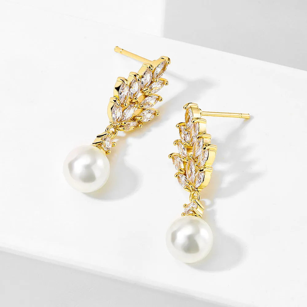 A pair of geometric stud earrings with a flower design and micro inlaid zircon, shown in gold plating.