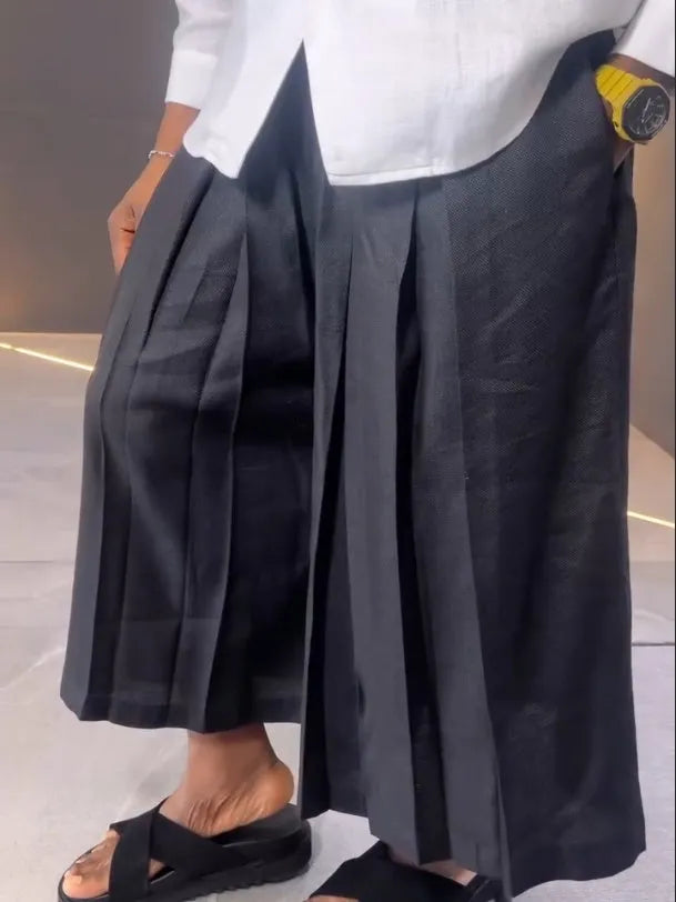 Women's white asymmetric long sleeve shirt and black pleated trousers co-ord set