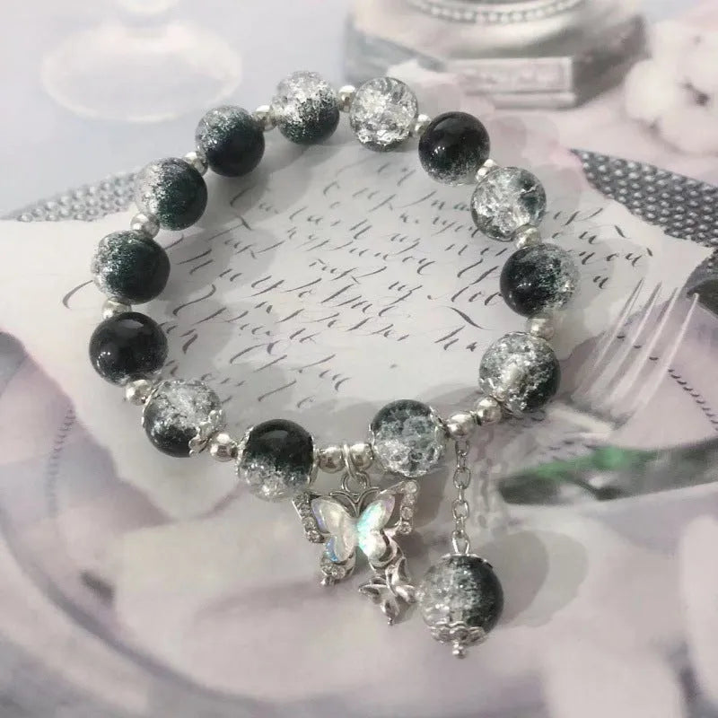 Chinese style glass bead bracelet with bamboo leaf design and manual craftsmanship details.