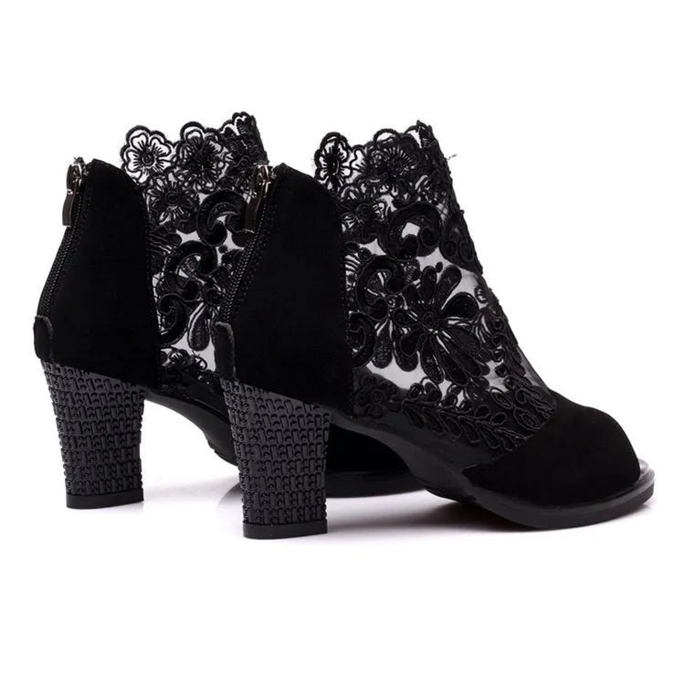 Black women's gladiator sandals with lace upper, square heel, zip closure, and peep toe.