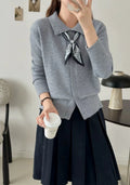 Beige lapel scarf cardigan sweater with long sleeves and splicing detail on a hanger.