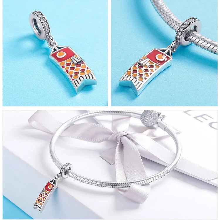 S925 sterling silver carp streamer pendant necklace with zircon detailing on a dark background.