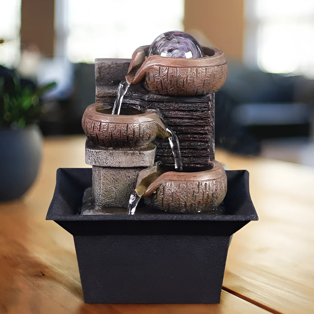 European desktop fountain with resin stone powder construction, crystal ball, and flowing water on a desk