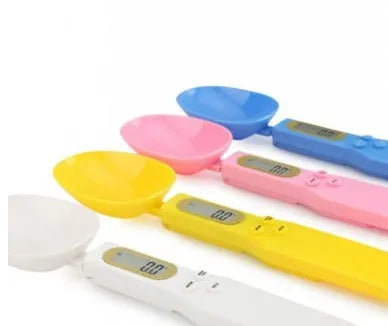 White digital spoon scale with LCD display measuring 500g capacity on a kitchen surface