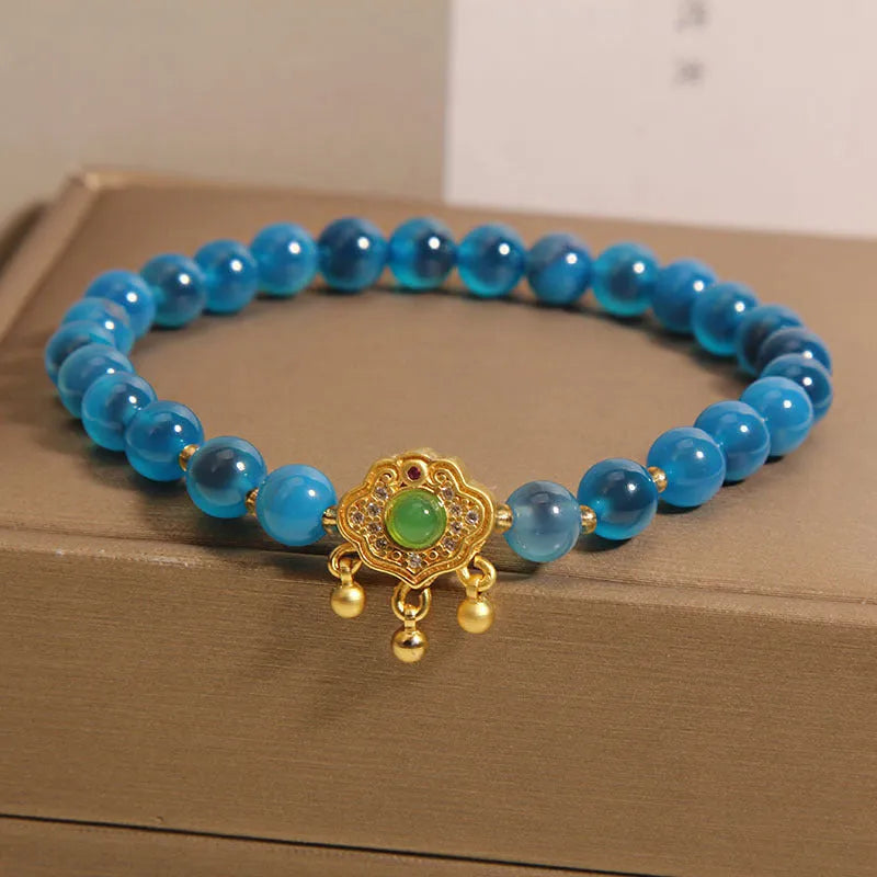 Women's blue sugar heart agate safety lock pendant bracelet with crystal and rhinestone details on alloy.