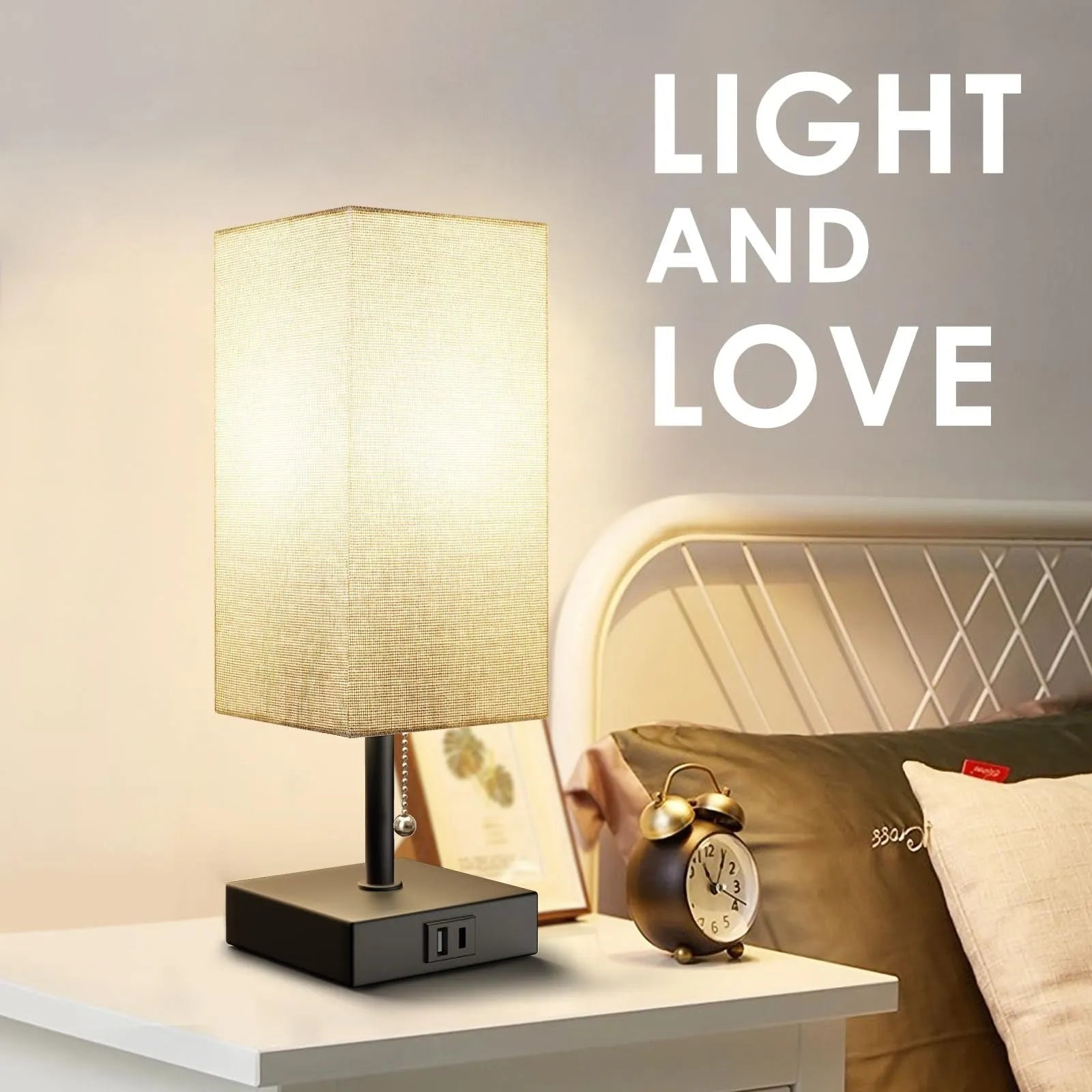 Small bedside table lamp with beige fabric shade and black base on a nightstand
