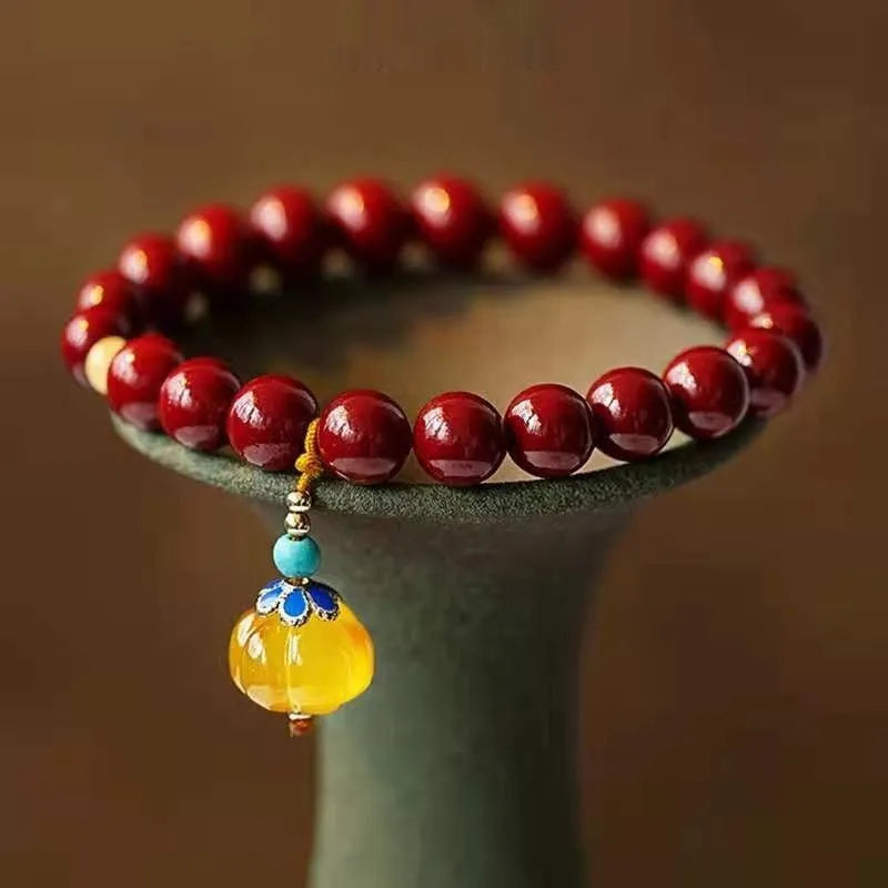 Handcrafted gold cinnabar bracelet with wave design in pumpkin cinnabar colour