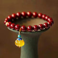 Handcrafted gold cinnabar bracelet with wave design in pumpkin cinnabar colour