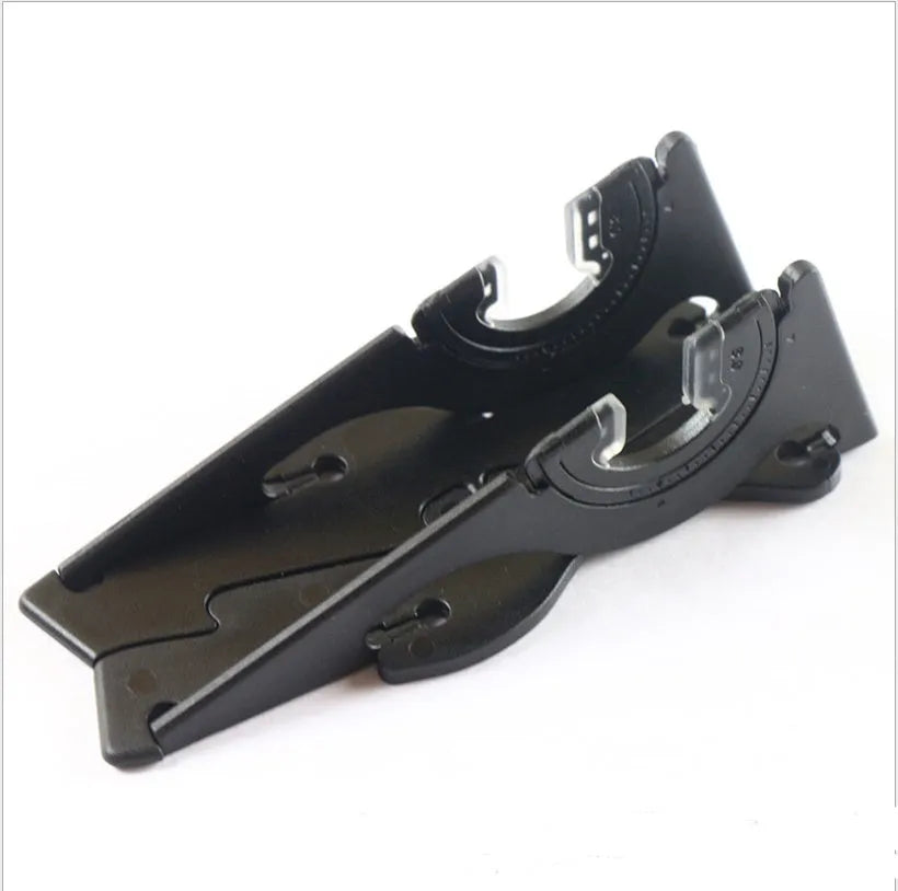 A black plastic card-type bracket holding a smartphone upright on a desk.
