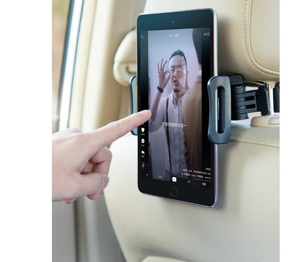 Black car phone holder mounted to rear seat base holding tablet for navigation