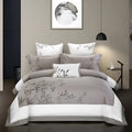 Four-piece embroidered cotton bedding set in chosen pattern on bed