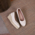 Apricot wedge heel pumps with a shallow-cut vamp and rope-like trim on a thick EVA sole.