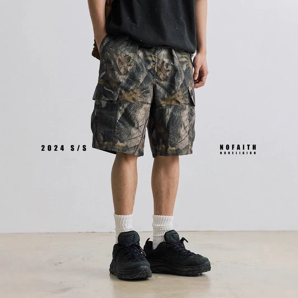 Loose fit straight-leg denim shorts in black or army green on a hanger, showing mid-waist and zip fly detail.