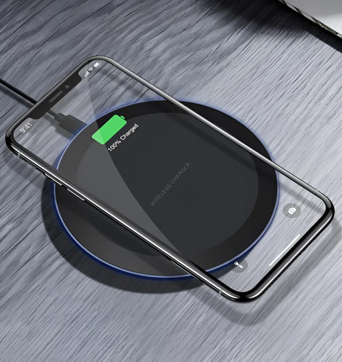 10W/5W black fast wireless phone charger pad on desk with iPhone - 100mm diameter, 8mm thick