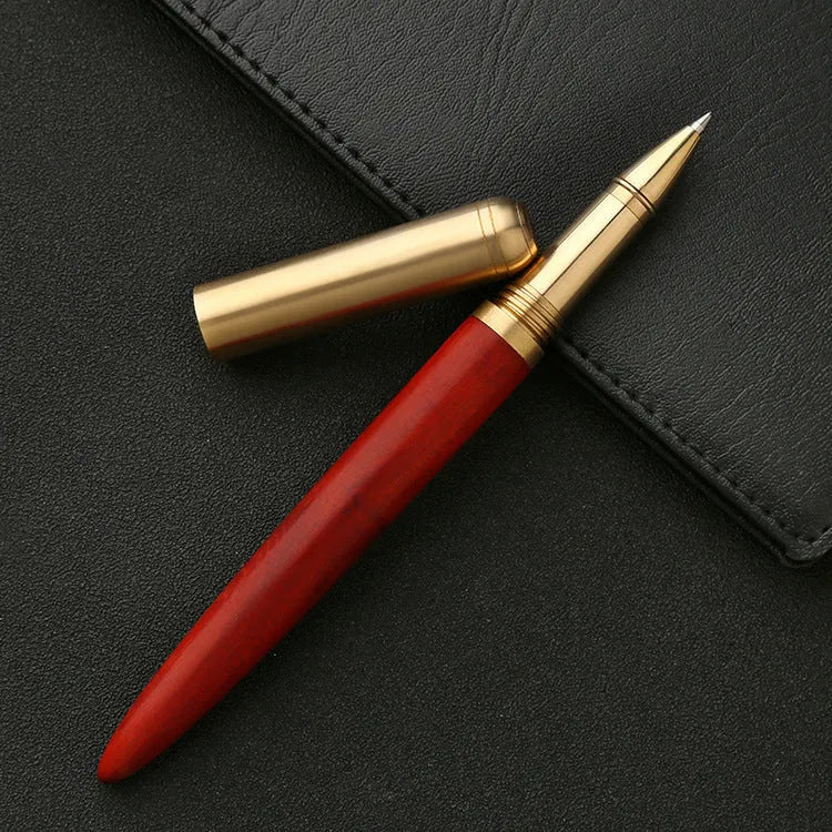 Brass sandalwood signature pen 14cm with wood barrel on a flat surface