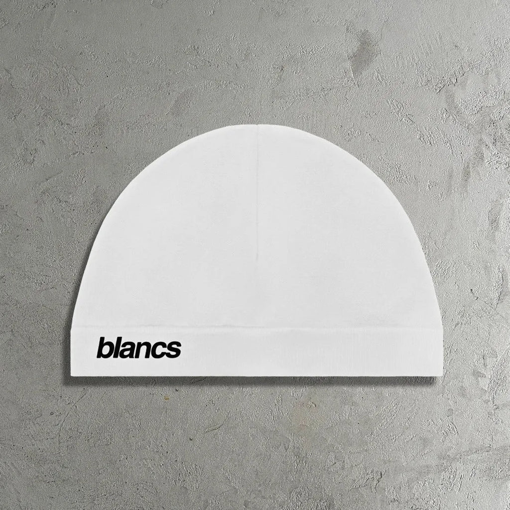 White polyester cap with embroidered letter detail, front view
