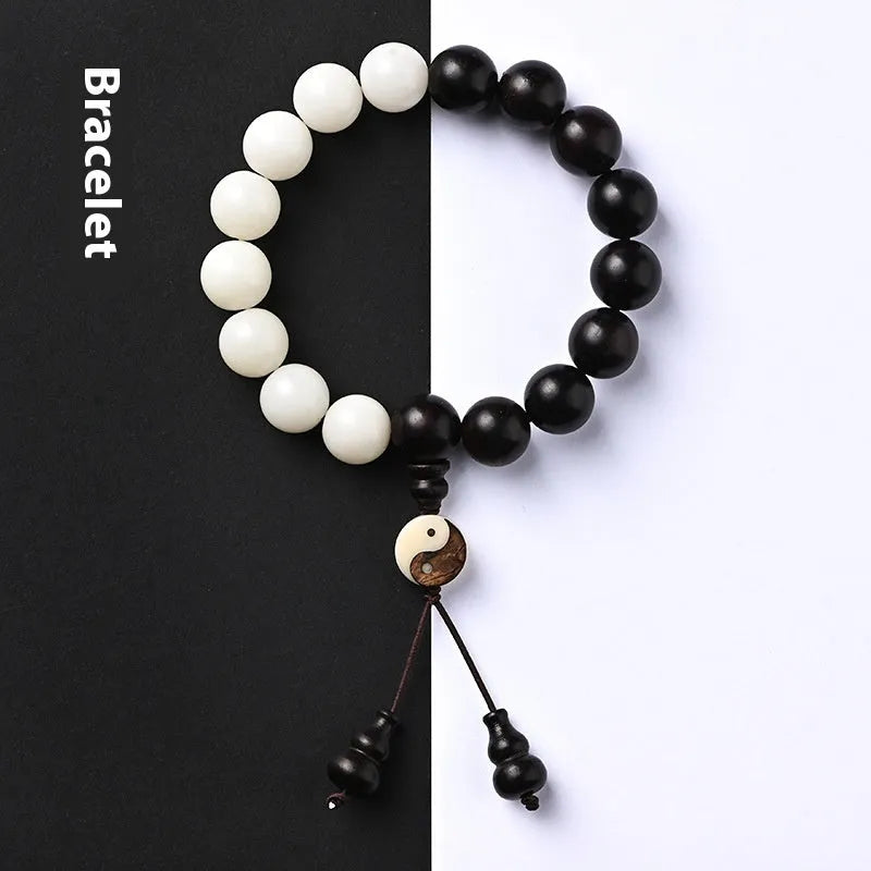 Close-up of a white retro eight-diagram-shaped Bodhi bead bracelet with 11mm beads on a black background.