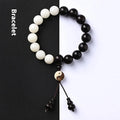 Close-up of a white retro eight-diagram-shaped Bodhi bead bracelet with 11mm beads on a black background.