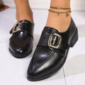 Women's classic black slip-on flat shoes with a large decorative bow on the toe.