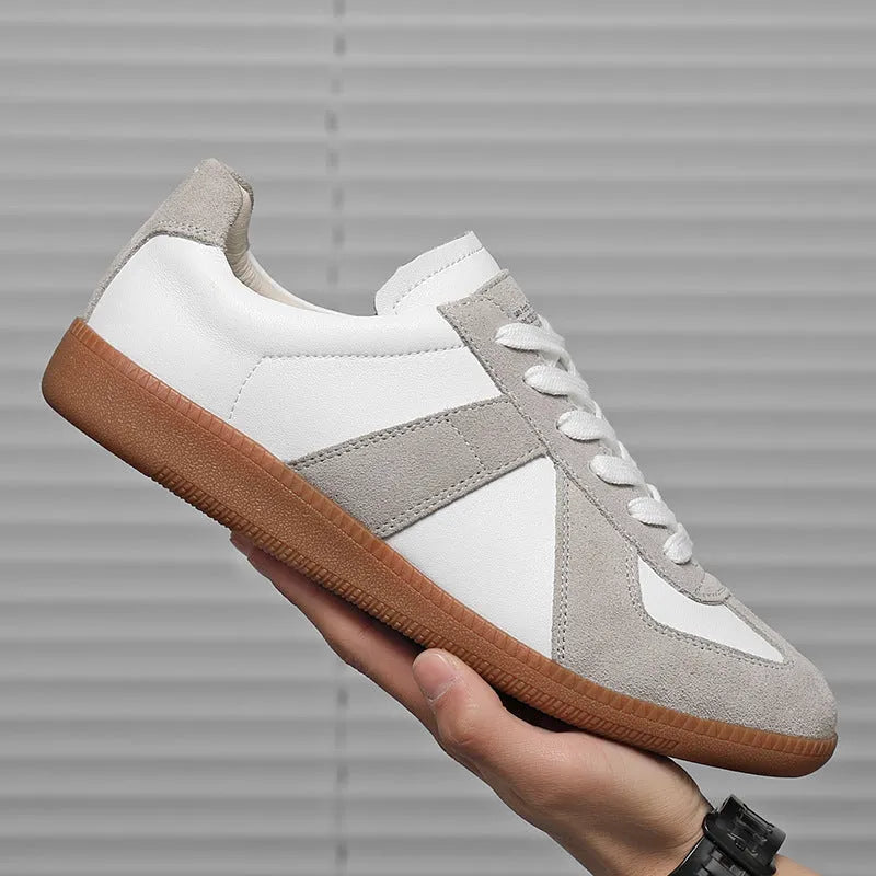 White Japanese-style retro low-top sneakers with round toe and flat rubber sole on a solid background.