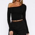 Women's long sleeve slim fit knitted cardigan in black with a cross shoulder strap detail.