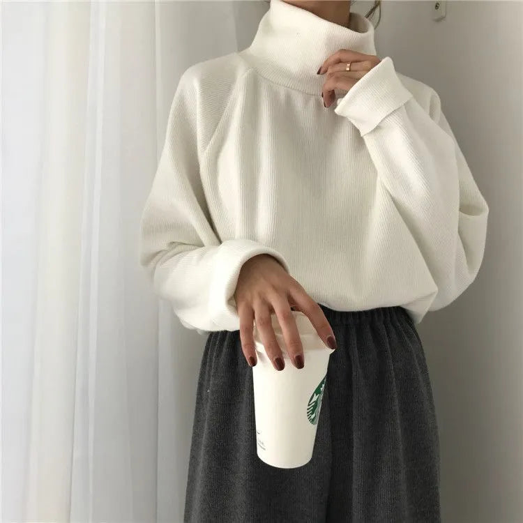 Women's loose fit long sleeve top in solid colour with a half-high collar.