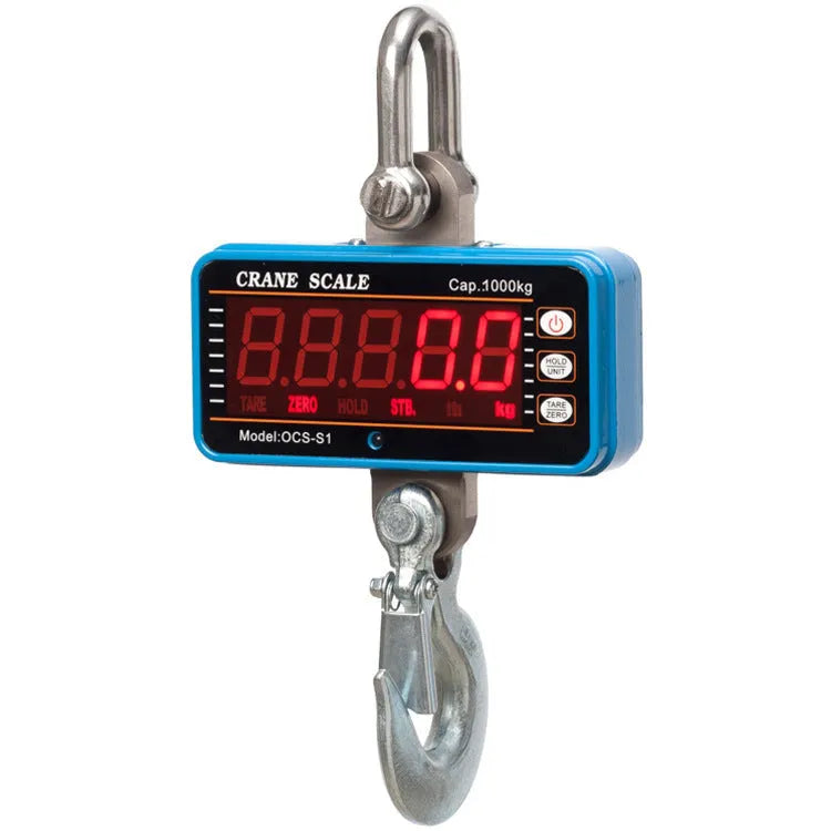 Orange electronic crane scale with digital display, showing a weight readout, hooked to a chain for lifting.