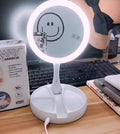 White foldable LED vanity mirror with storage compartments and USB charging port