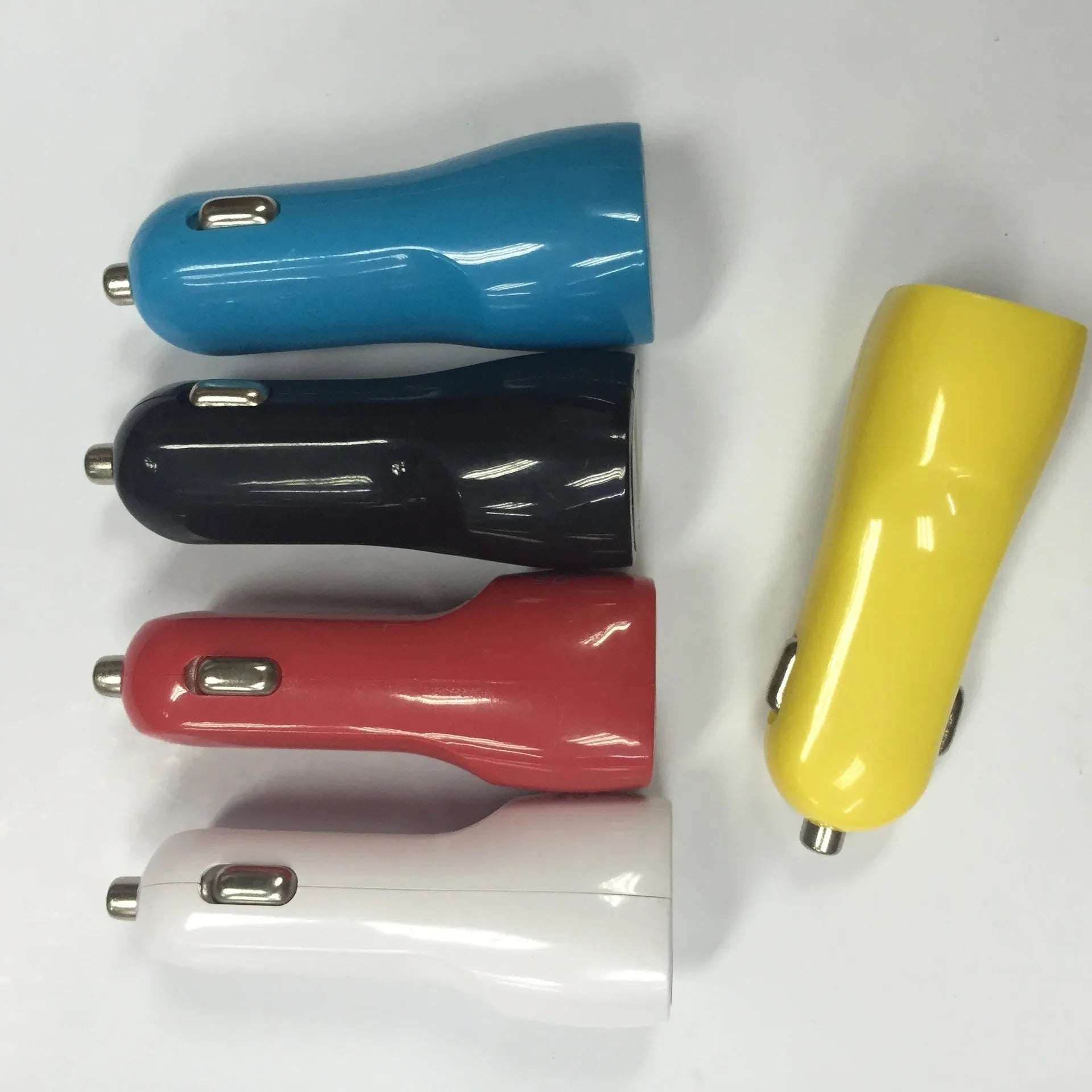 Dual USB car charger with blue LED indicator light and piano paint finish measuring 6x4.2x4.2cm