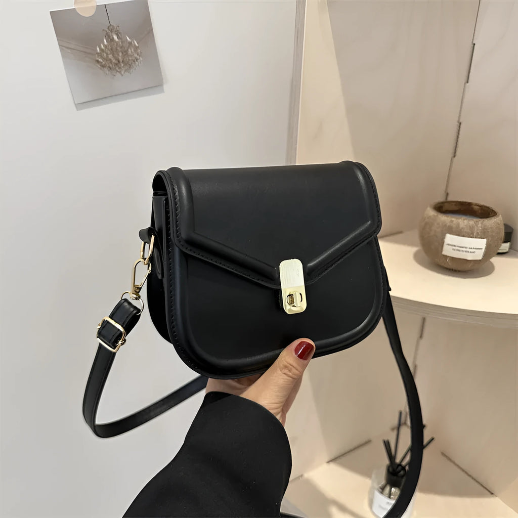 Soft PU leather clamshell shoulder messenger bag in horizontal square shape on adjustable strap.