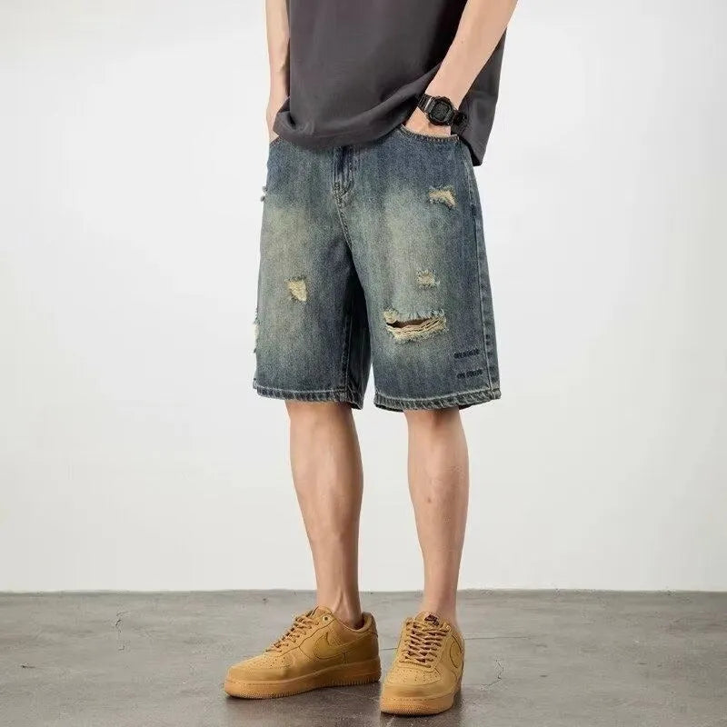 Blue distressed denim men's shorts with a loose retro fit and hole detailing