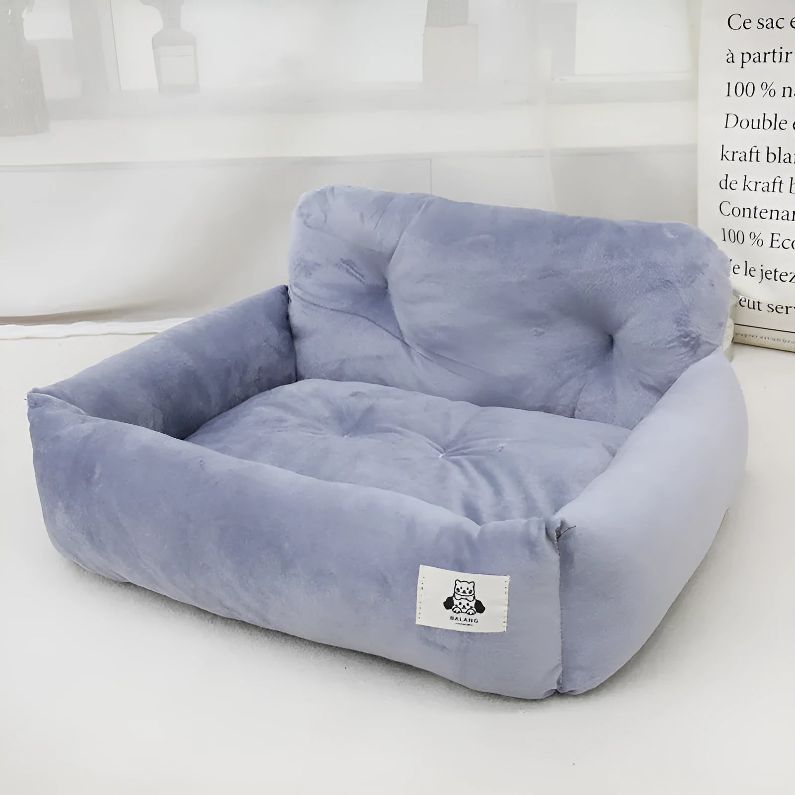Car-mounted pet outing nest in grey and blue plaid options showing stain-resistant cloth construction