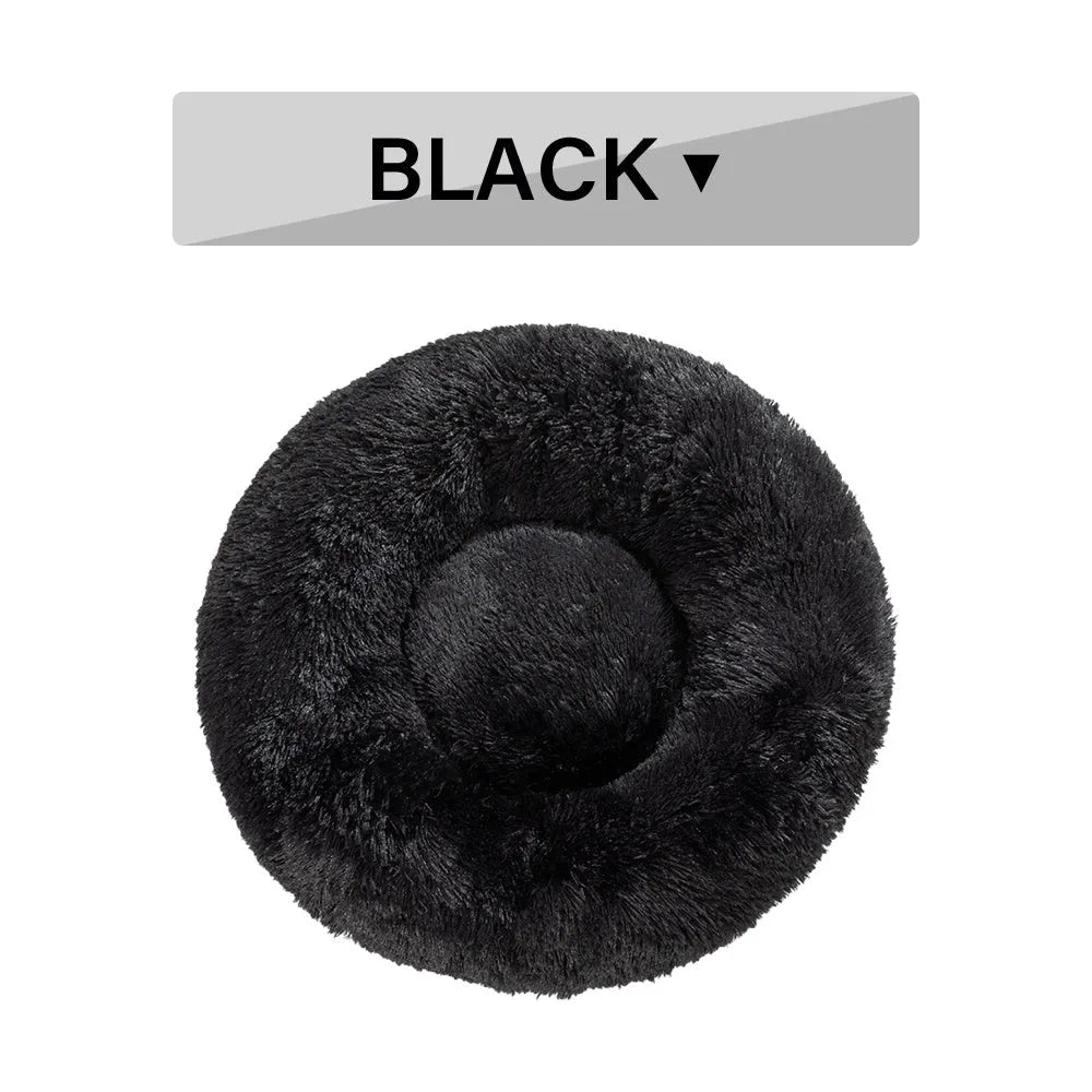 Fluffy donut-shaped dog bed in light grey plush material, showing raised rim and central cushion.