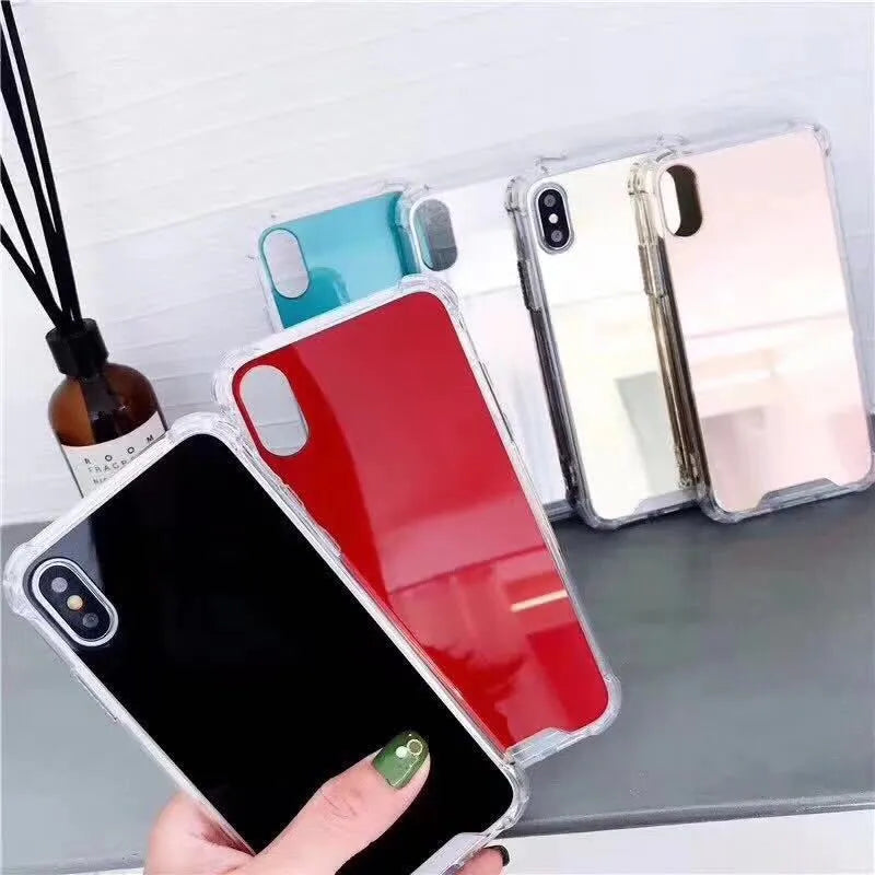 Mirrored front TPU protective case for iPhone in multiple colour options on a table.