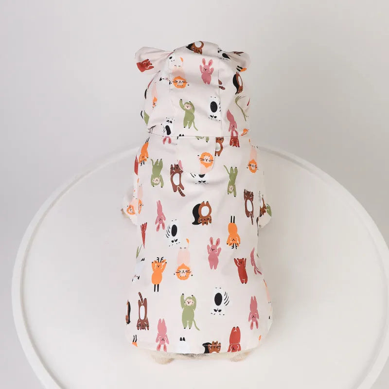 Beige dog raincoat with cartoon animal design showing waterproof PU construction