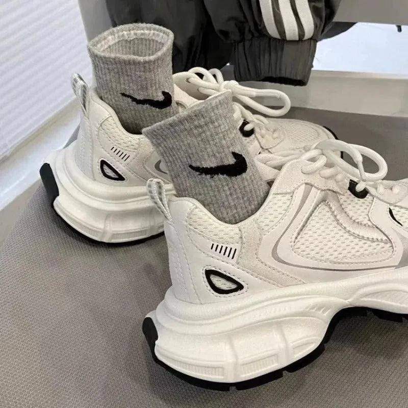 Beige mesh platform sports shoes with a wedge heel and lace-up front.