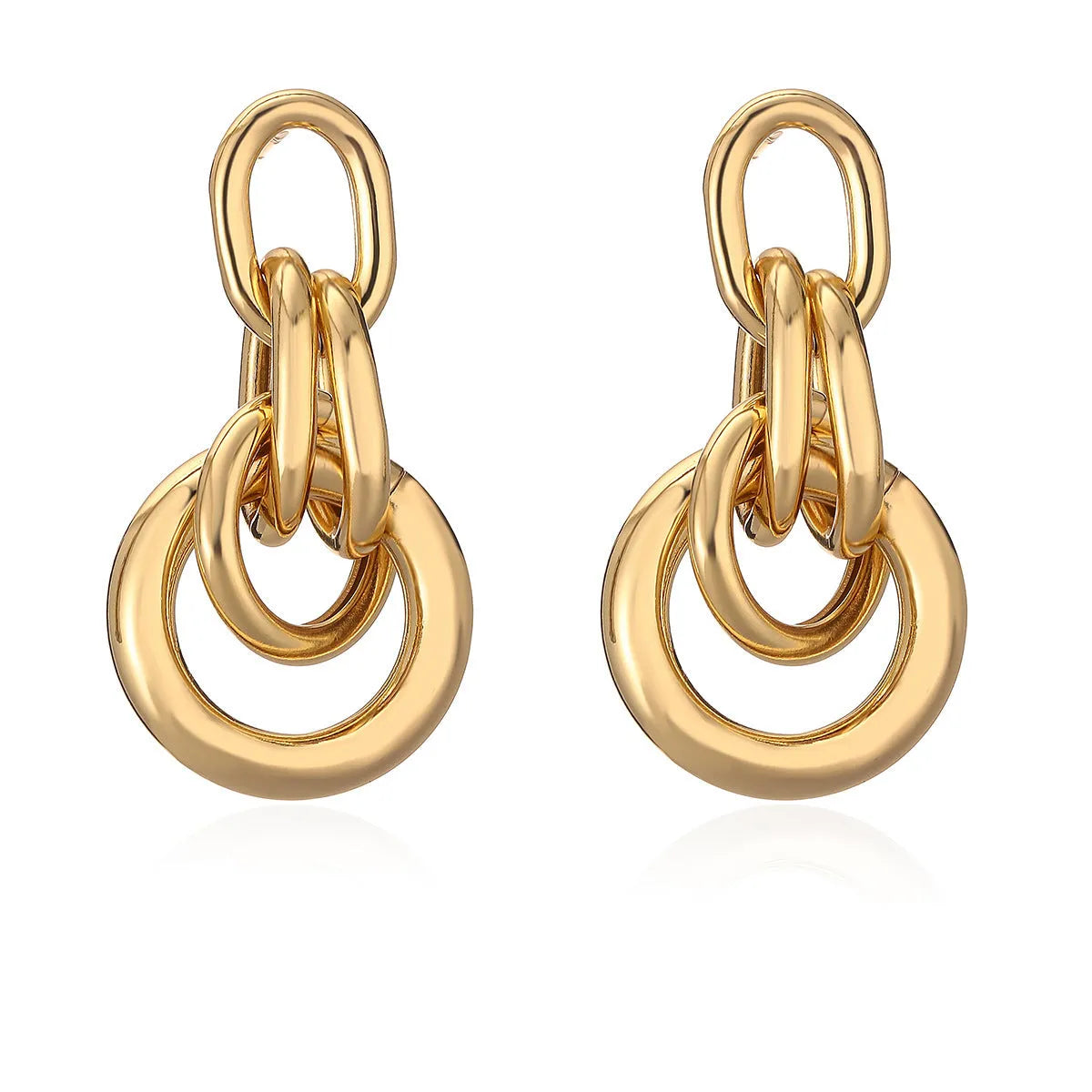 A pair of gold-coloured geometric earrings with an irregular shape on a white background.