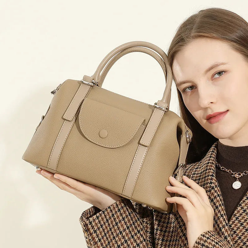 Genuine leather ladies' handbag in black with stitching detail, measuring 27cm wide