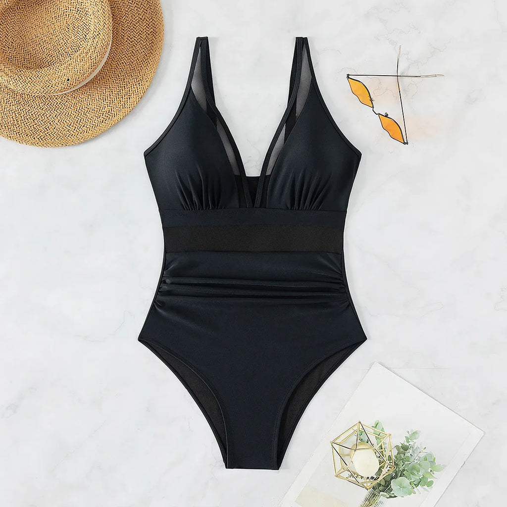 Black women's one-piece swimsuit with halter neck and briefs-style bottom made of nylon.